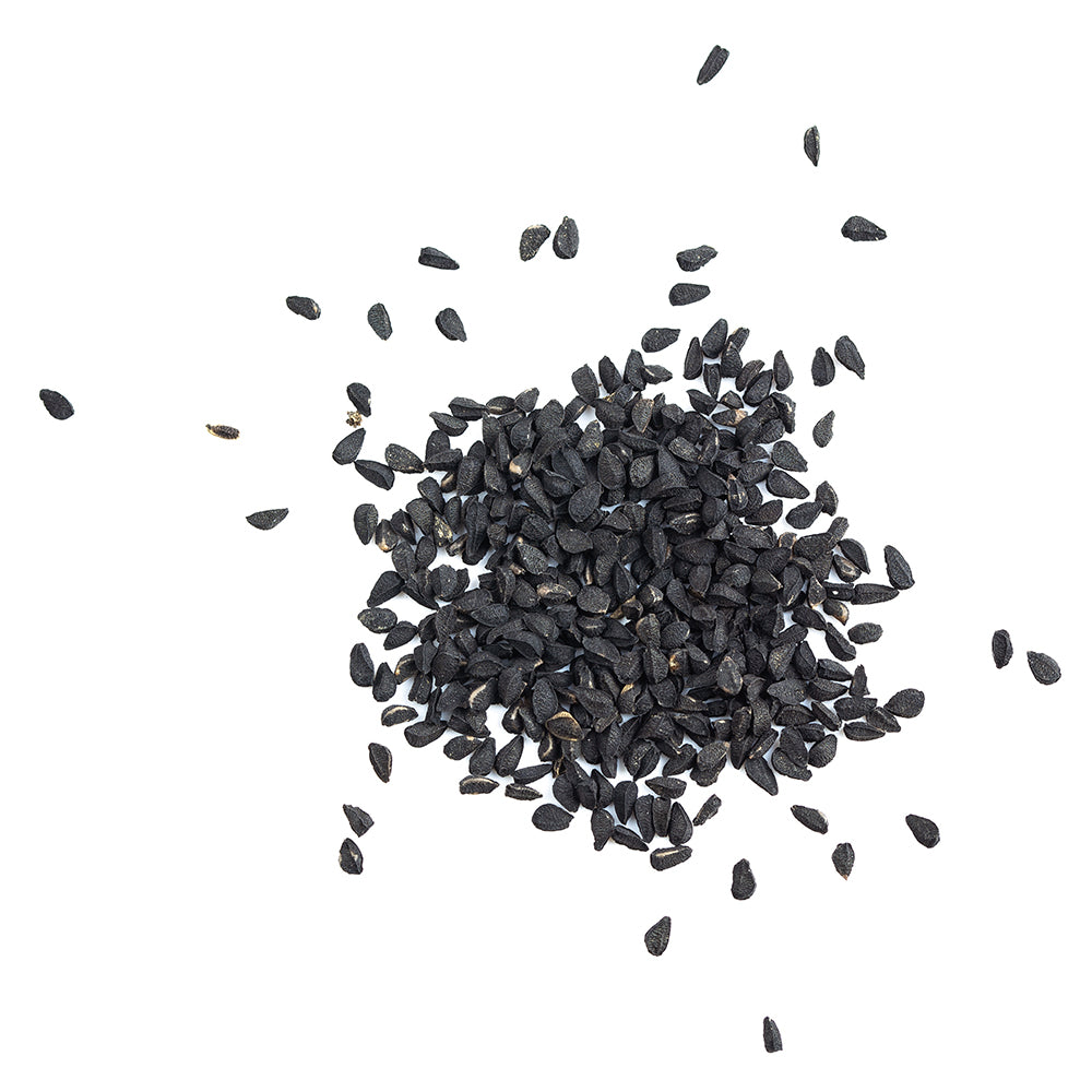 black cumin seeds on a white background